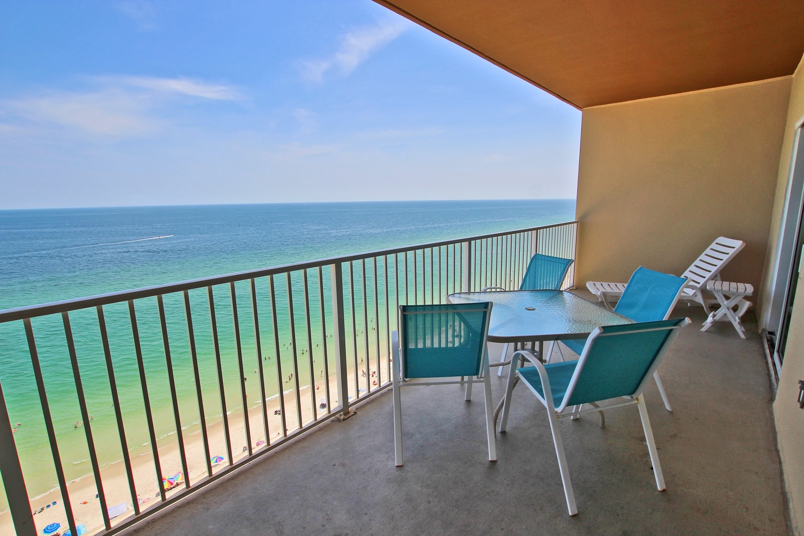 ocean front balcony with table and four chairs